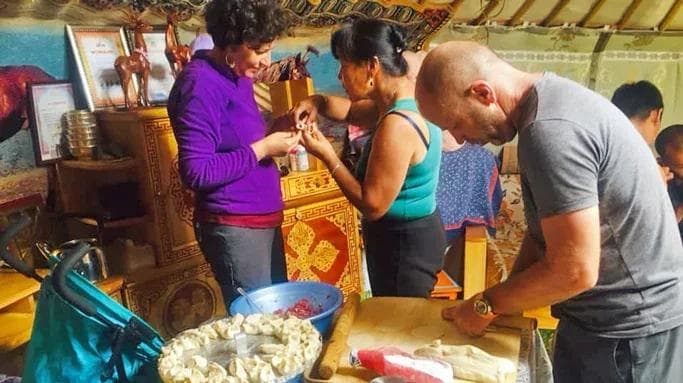 tourists making mongolian food